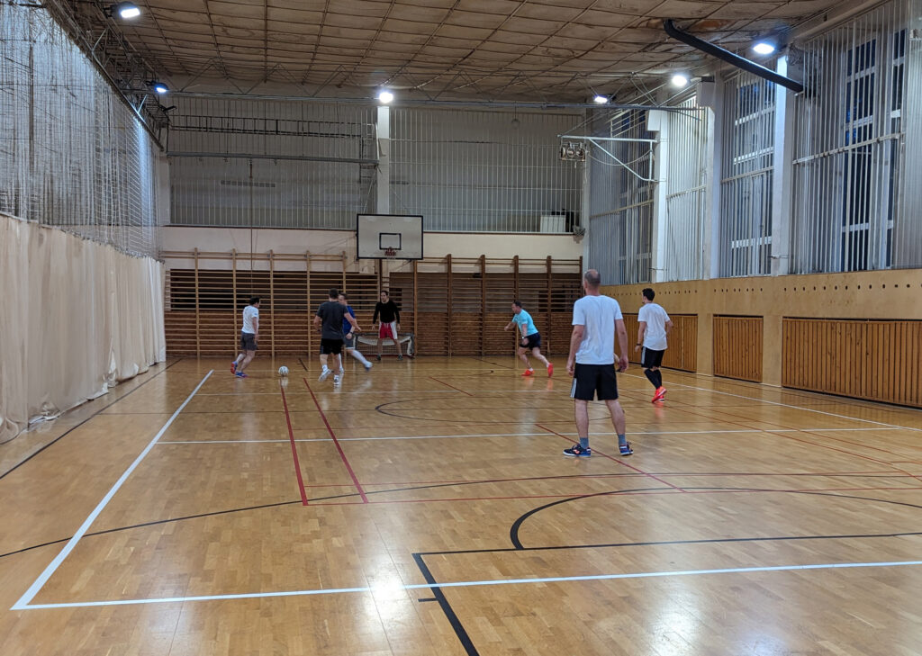 men in a sports hall playing football