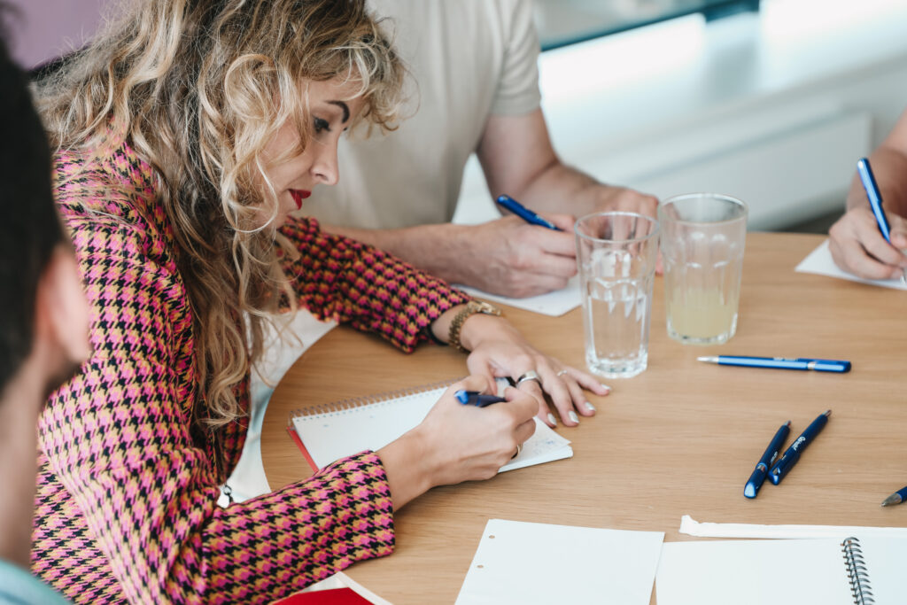 female project manager writing on a piece of paper