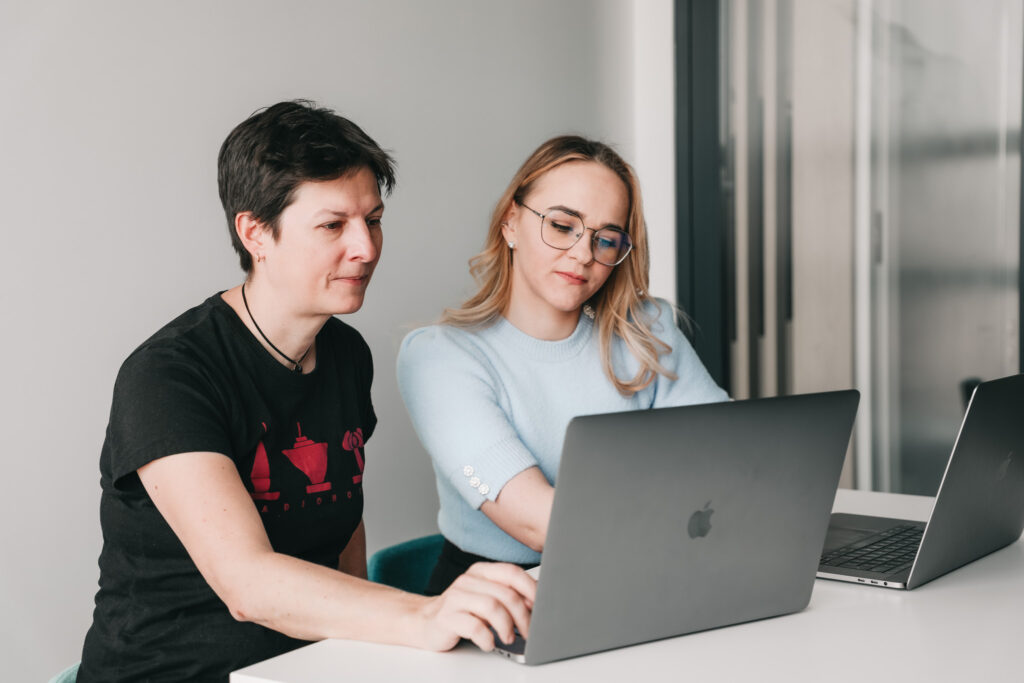 two female colleagues working on a laptop